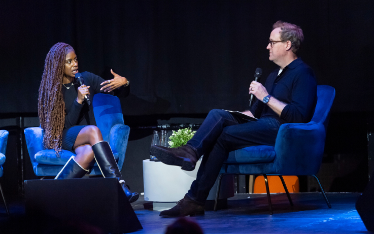 Two people on stage talking at an IAB UK event