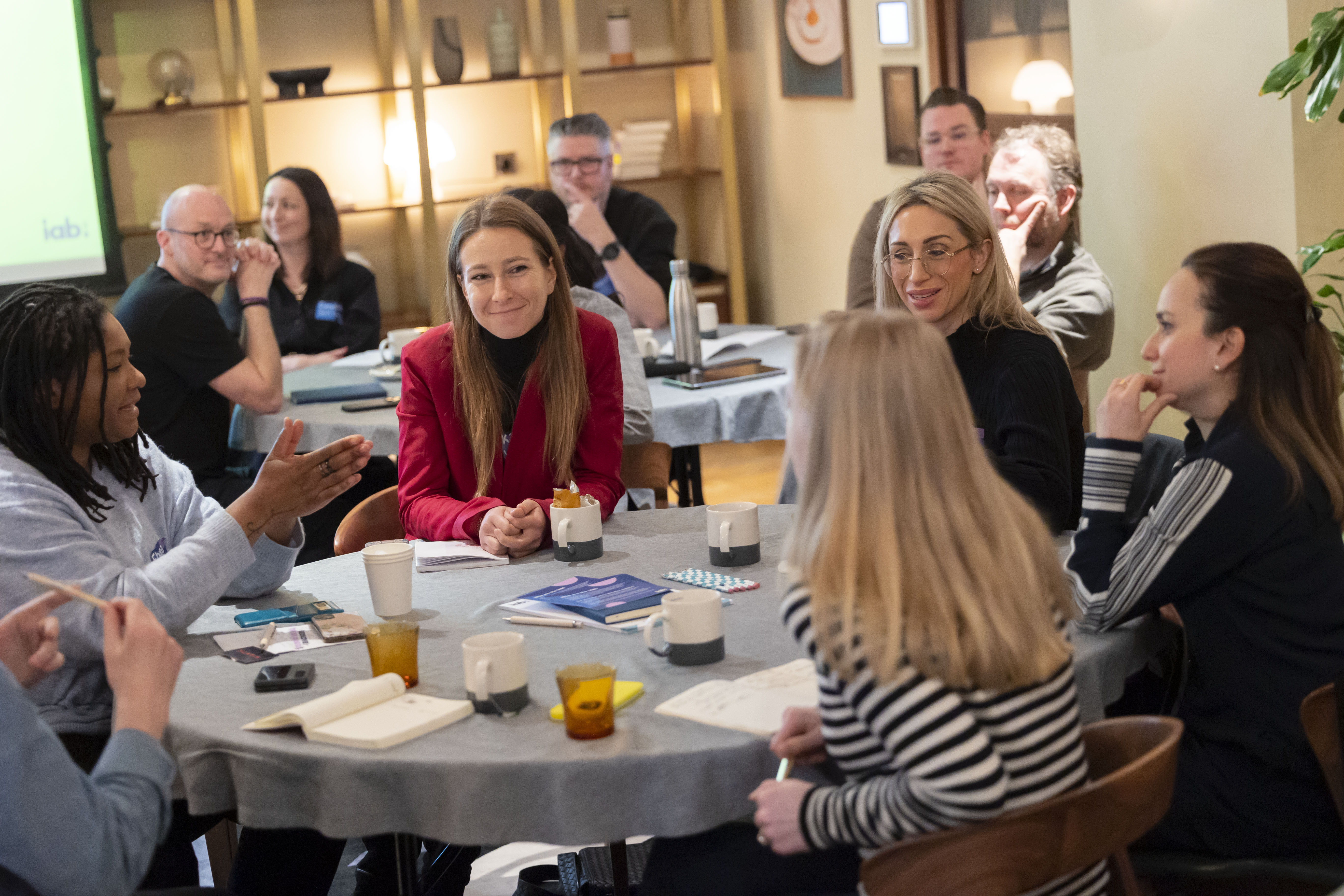 People sitting at a round table interacting 