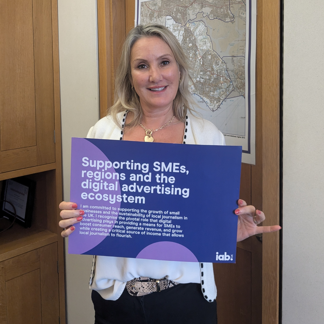 Caroline Dinenage, MP for Gosport, holding up IAB UK pledge