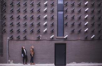 Two ladies looking at CCTV surveillance cameras