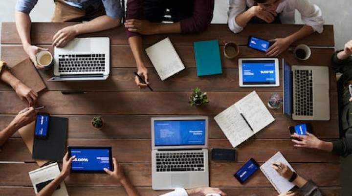 People at a table on a laptop 