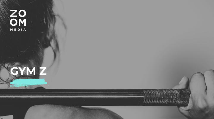 A woman holding a barbell on her back with the title 'Gym Z'