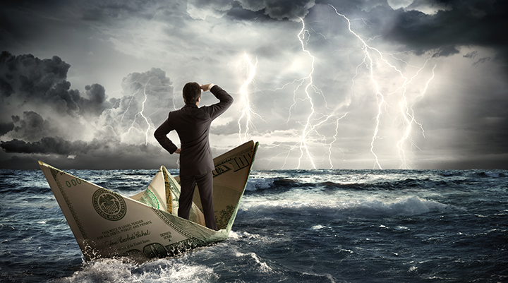 Person standing in a boat in the sea