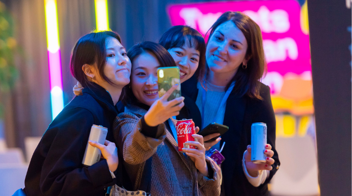 Women gathering around a smartphone