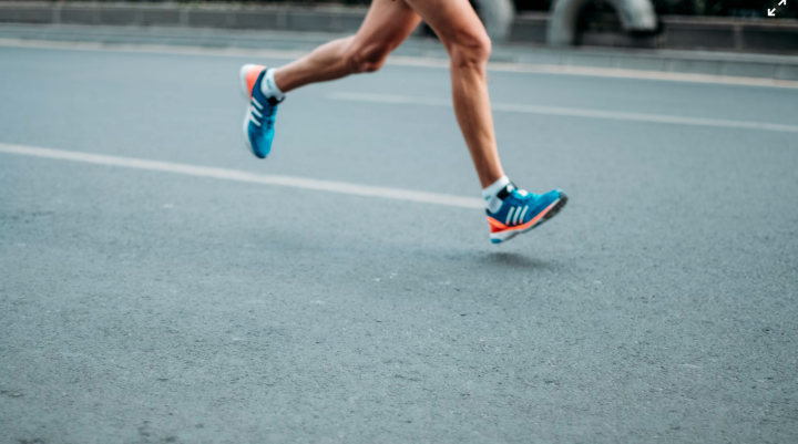 Person running on tarmac road