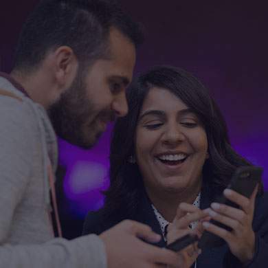 a lady showing a man something fun on her phone