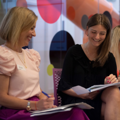 Two women in IAB UK office looking at a document