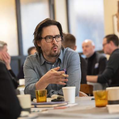 Man talking to others