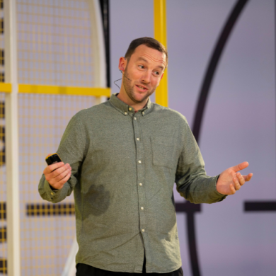 A man presenting on stage