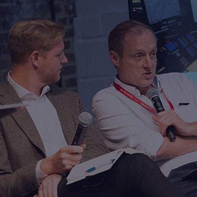 Stock image of two men talking into microphones