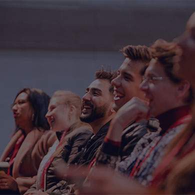 Stock image of people sitting in a line and laughing