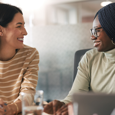 Two women smiling at each other