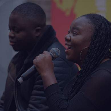 Stock image of a woman speaking into a microphone