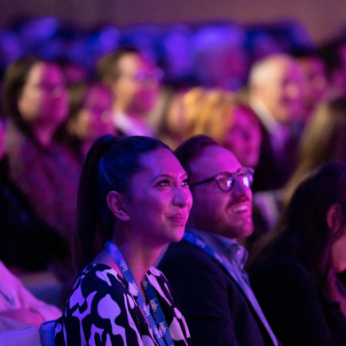 Two individuals attentively observing a talk.