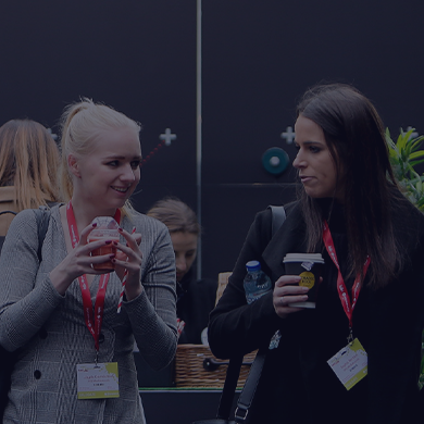 Stock image of two female humans speaking to each other