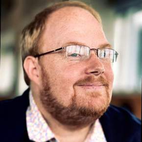 A headshot of Andy Dobson smiling.