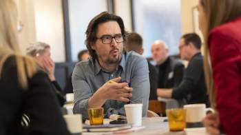 Man talking to others