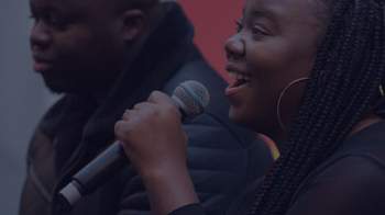 Stock image of a woman speaking into a microphone