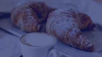 A picture of a cappuccino and croissants 