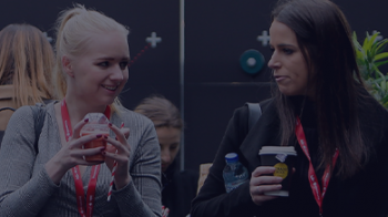 Stock image of two female humans speaking to each other