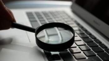 Magnifying glass over computer keyboard