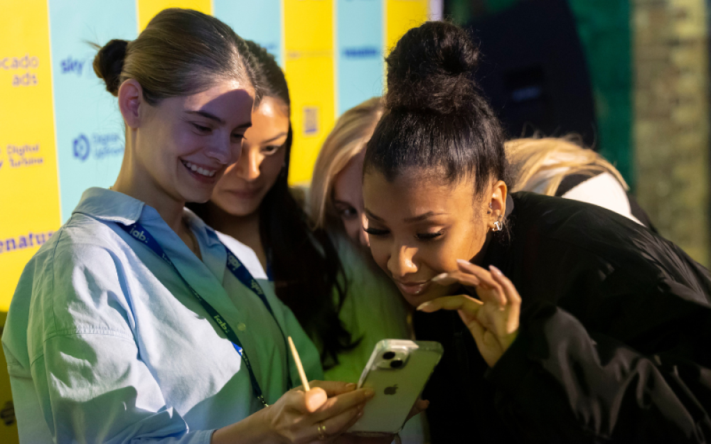 a group of members checking a phone